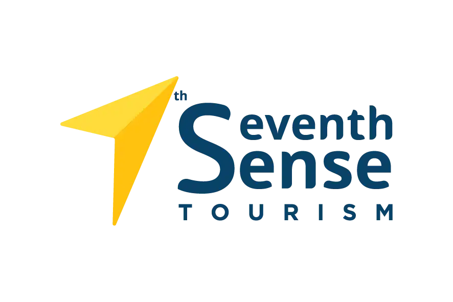 Seventh Sense Tourism logo with yellow paper plane icon and blue text