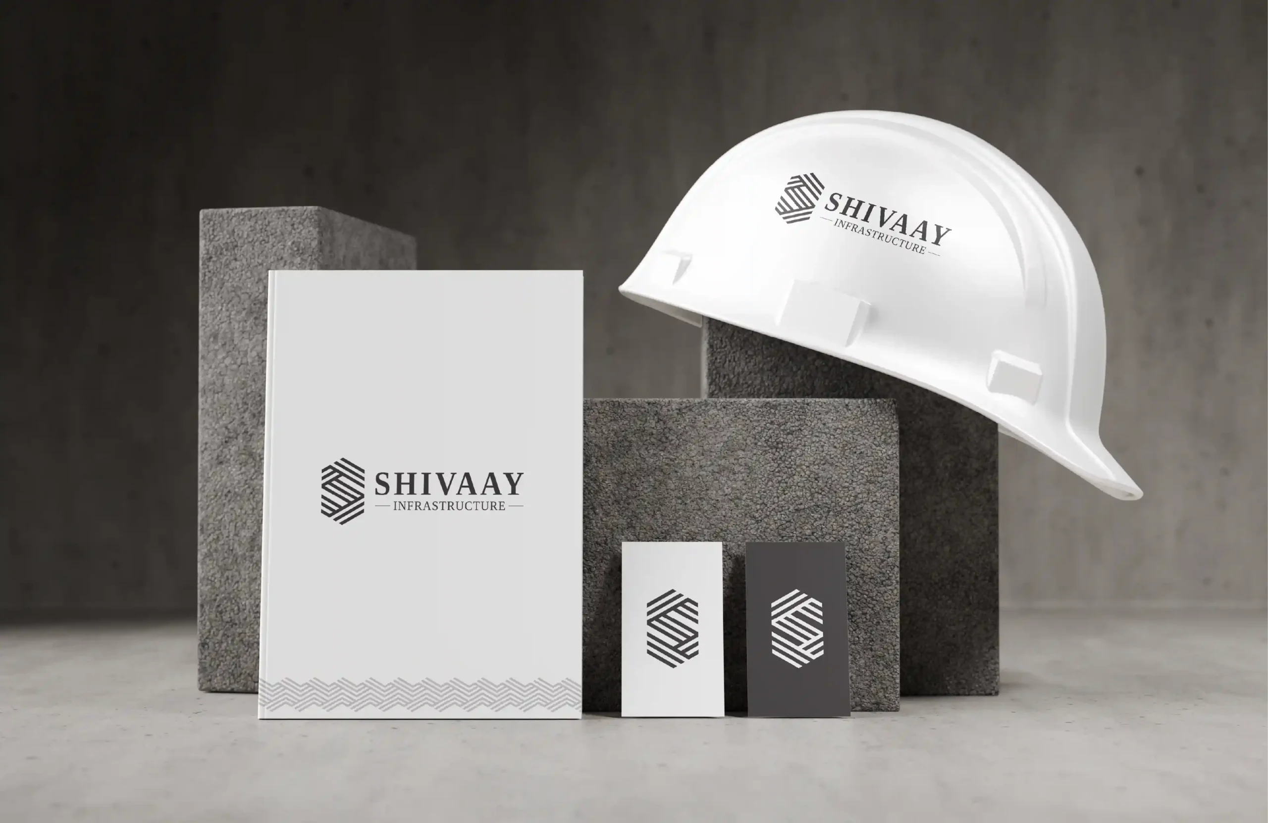 Shivaay Infrastructure logo branding mockup featuring stationery cards and branded safety helmet for infrastructure company identity design.