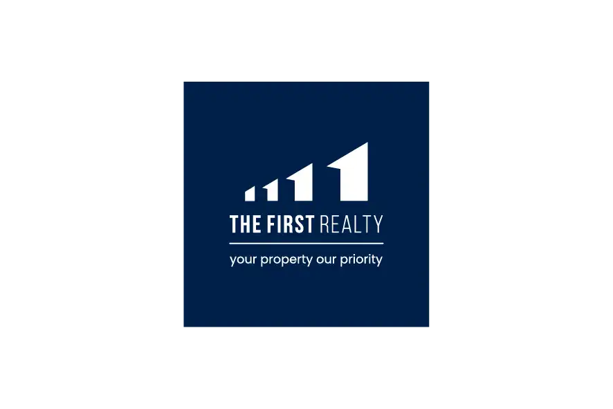 The First Realty logo on dark blue background with white text