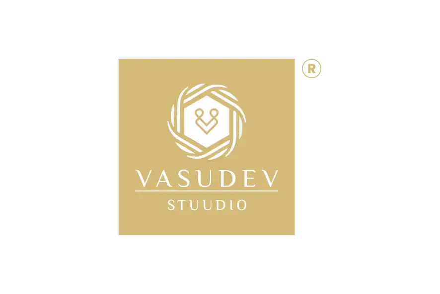 Vasudev Stuudio logo on beige background with white emblem and text.