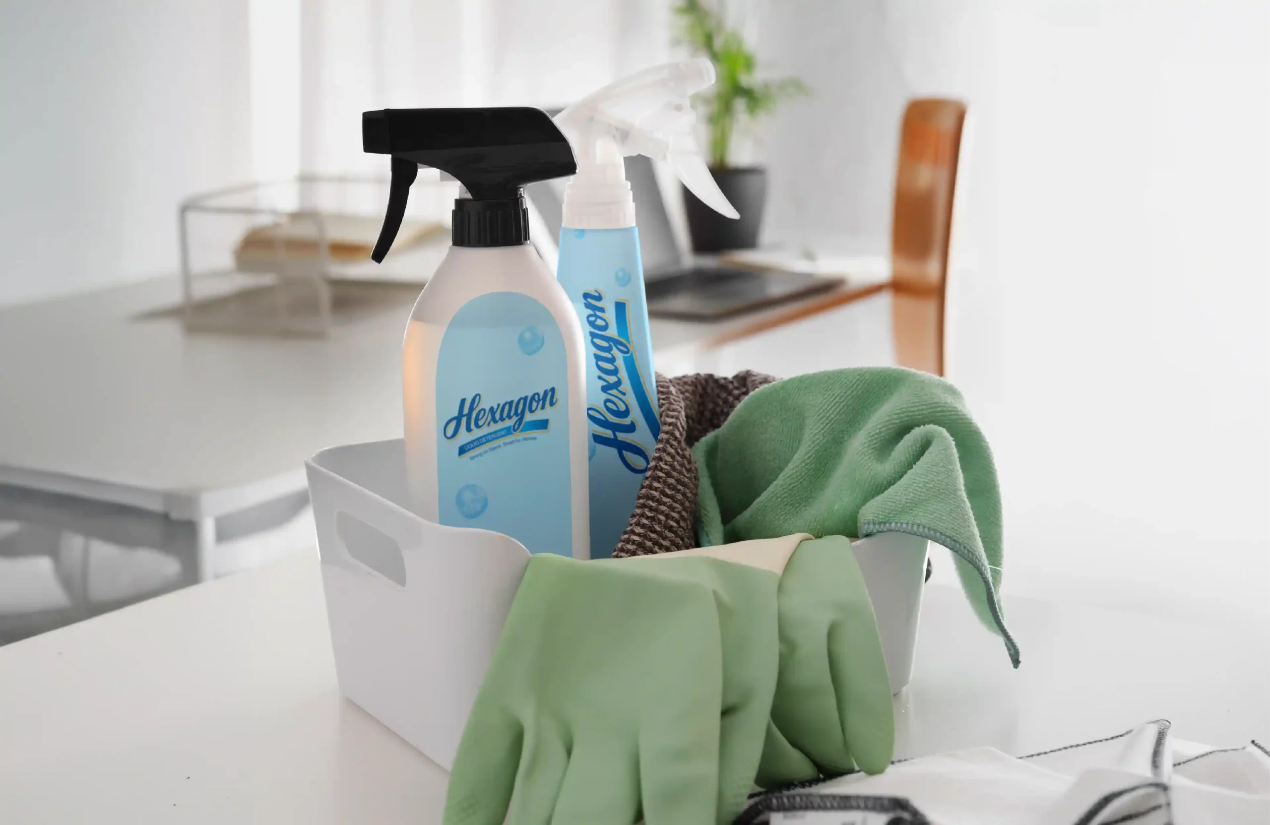 Hexagon liquid detergent spray bottles displayed with cleaning cloths and green rubber gloves.