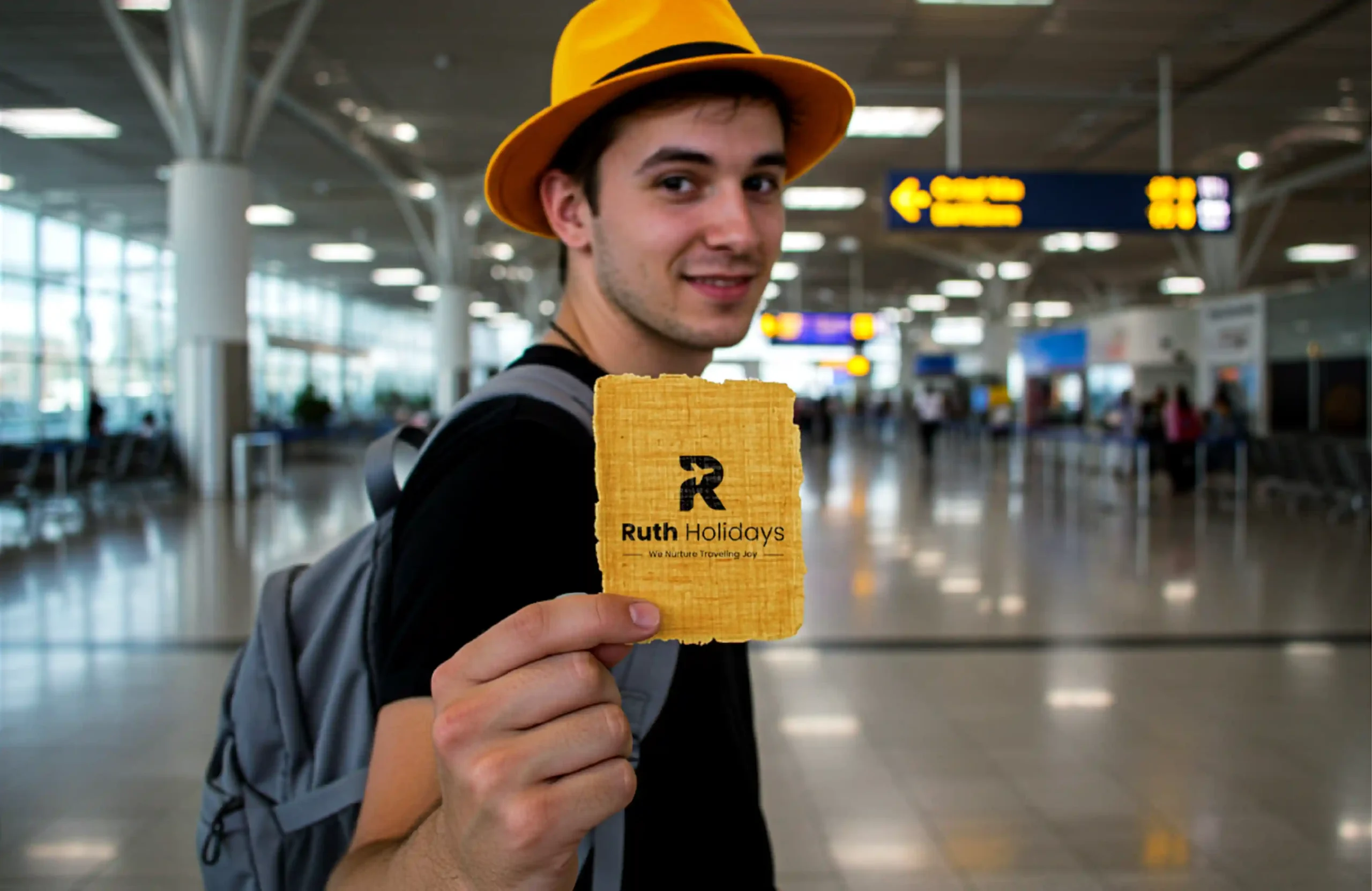 Traveller holding a Ruth Holidays branded card inside a modern airport terminal.